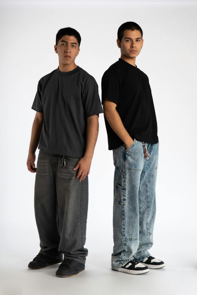 Two young adults in casual streetwear, showcasing 90s fashion style.