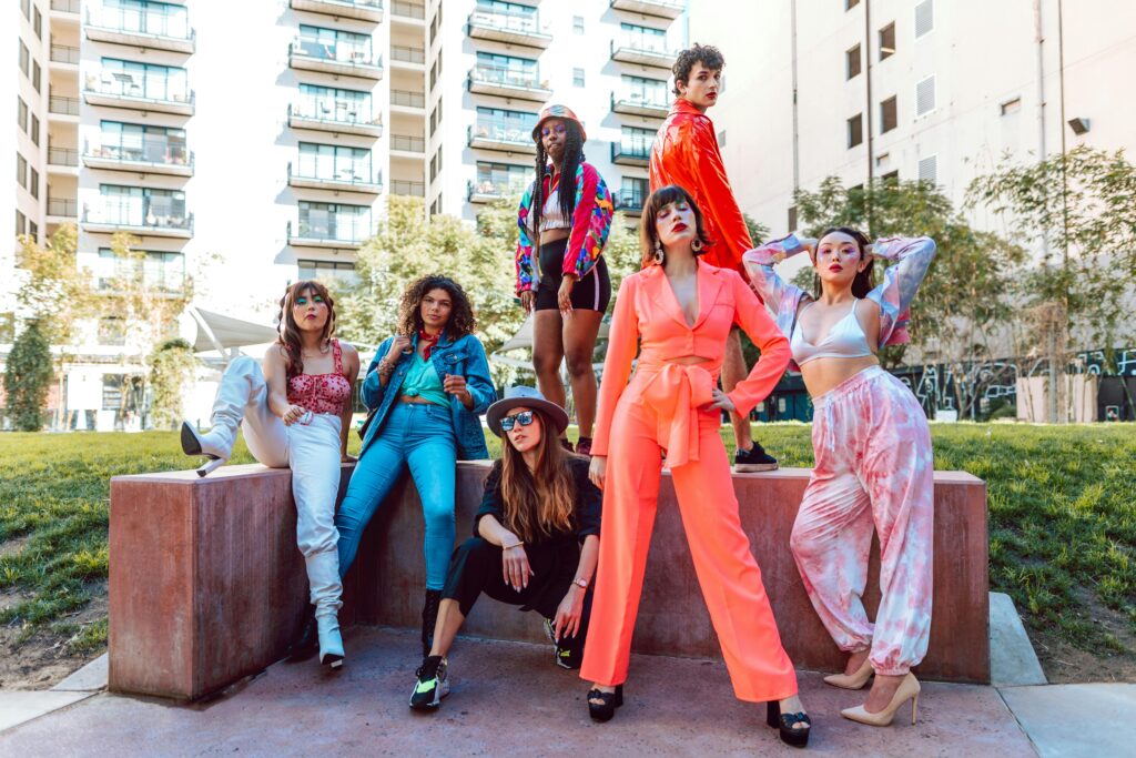 A fashion-forward diverse group showcasing vibrant street style in a city backdrop.